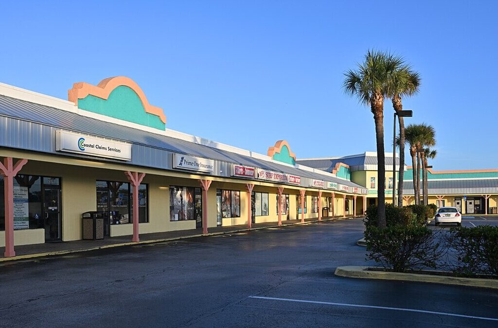 Small business storefronts in a Florida strip mall, relevant to hurricane season exterior prep for Orlando commercial property